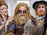 Three white characters wearing elaborate period costumes representing significant historical figures