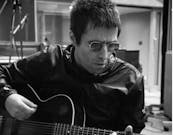 man in sunglasses plays an acoustic guitar