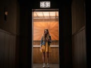 A young white girl looking terrified in a lift