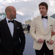 Two white men in bowtie and suits, and mixed race Puerto Rican woman in an elegant strapless red dress