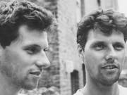 Black and white image of two identical young white men