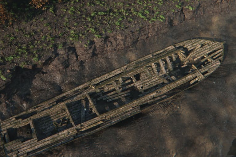Reconstructed image of a long wooden boat stuck in the mud with the water drained away