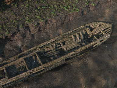Reconstructed image of a long wooden boat stuck in the mud with the water drained away