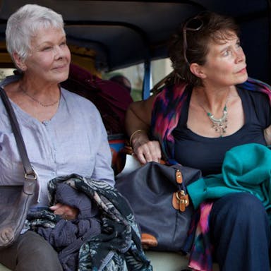 Two older women sat in the back of a ricksaw