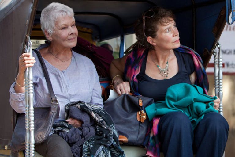 Two older women sat in the back of a ricksaw