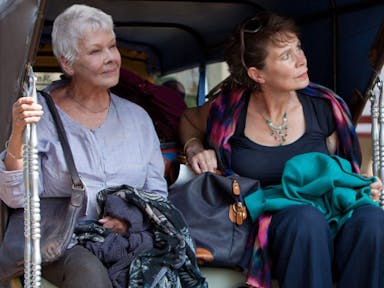 Two older women sat in the back of a ricksaw