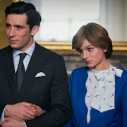 Young man in a smart suit and young woman in a smart 1980s style blue outfit hold hands and look to the side.