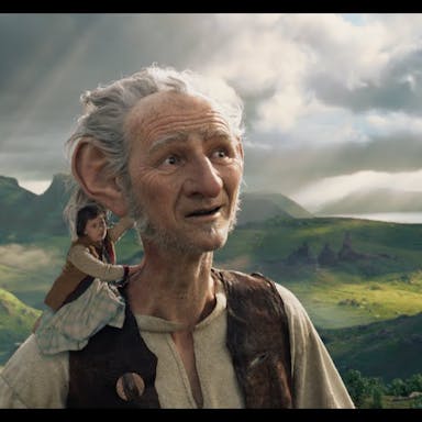 CGI white male giant with large ears in a magical rural landscape with a small girl on his shoulder 