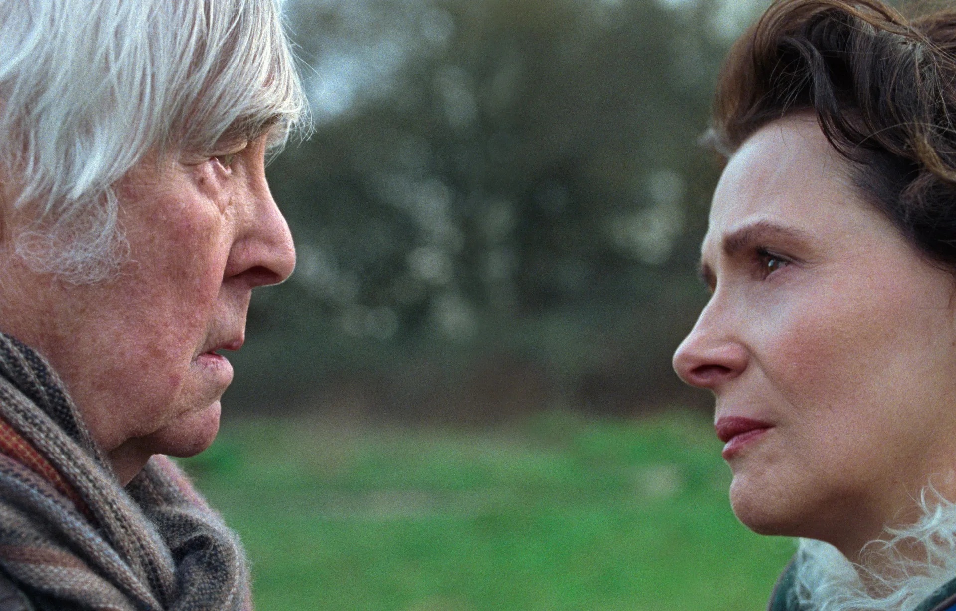 A middle aged white woman and older white man looking at eachother, with worried looks on their faces