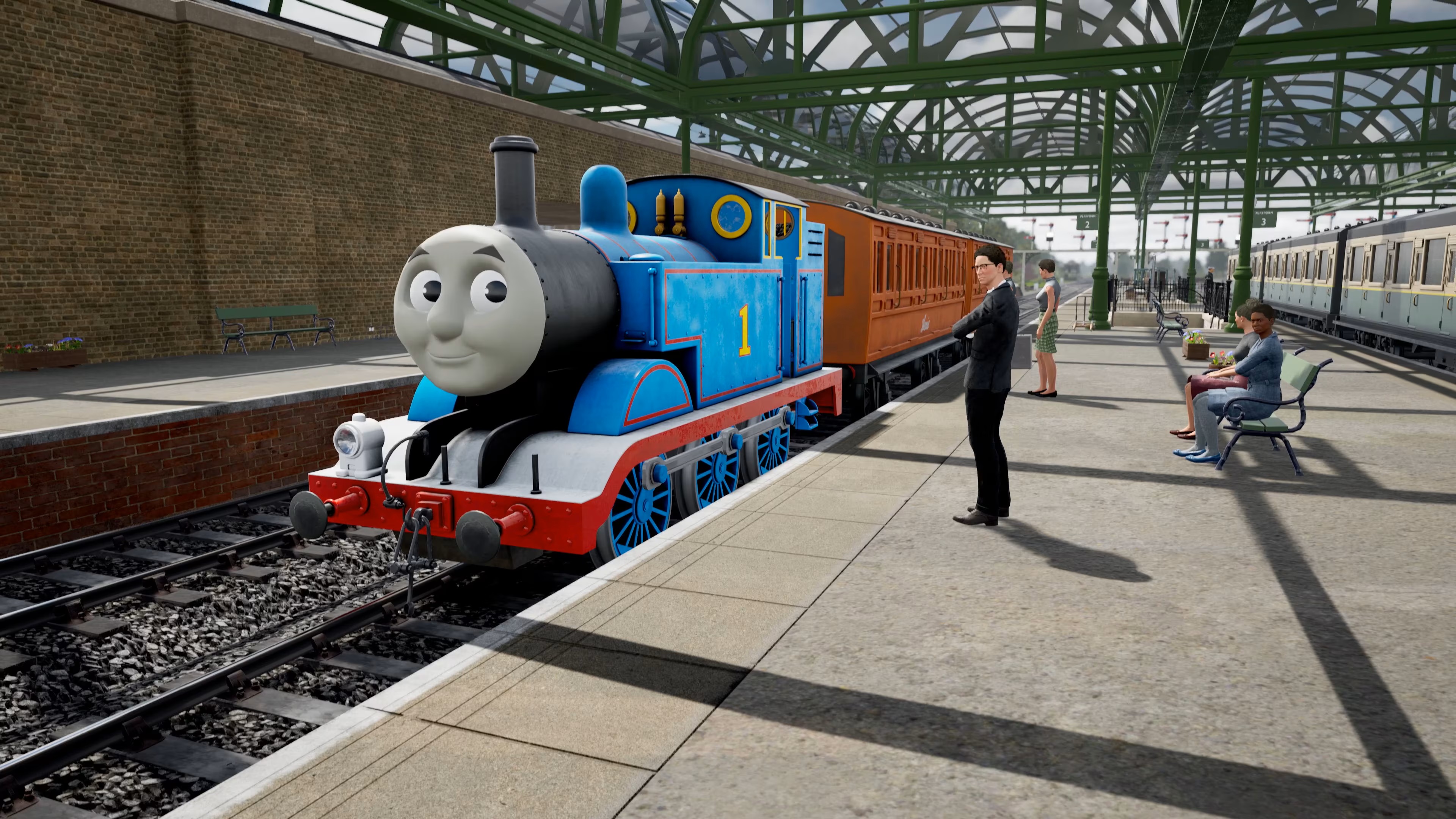 A blue train with a face on the front stopping at a station, a white suited man waiting to board