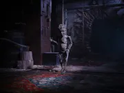 A small wooden puppet standing upright in a dark room