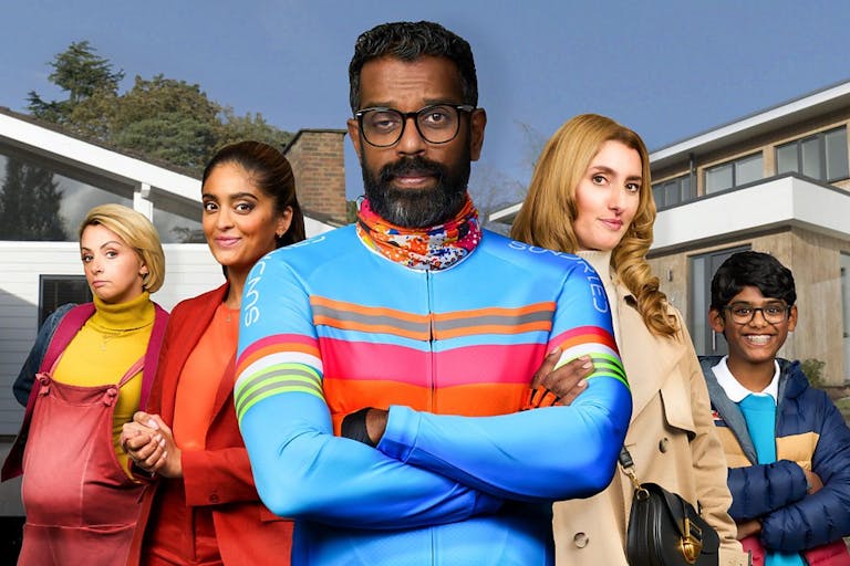 Four people posing in front of camera