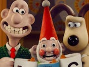 Stop motion plasticine characters, a bald white man with a large teethy smile and a beige and brown dog looking suspicious with an uncanny, overly smiley gnome between them