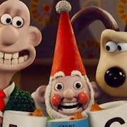 Stop motion plasticine characters, a bald white man with a large teethy smile and a beige and brown dog looking suspicious with an uncanny, overly smiley gnome between them