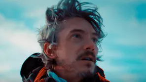 A close up of a man staring off camera with a look of shock
