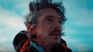 A close up of a man staring off camera with a look of shock