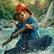 A CGI bear in blue coat and red hat, rafting on an open upturned umbrella down a river