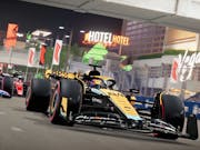 Gameplay of a yellow and black F1 race car on a track with other cars