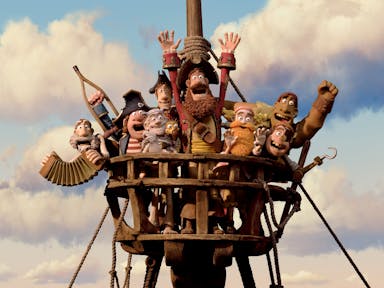 Claymation of a group of pirates atop a ship's wooden look out all cheering with their hands and objects in the air