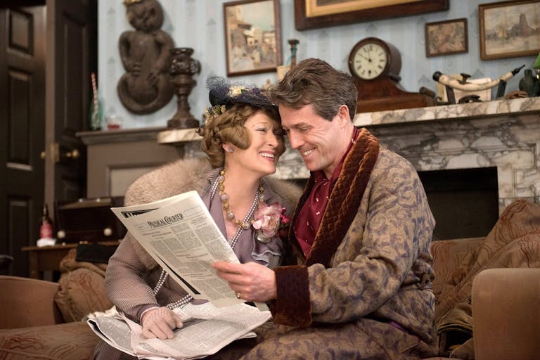 A middle aged woman and man in elegant robe and lounge clothing in a upper class house