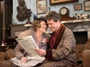 A middle aged woman and man in elegant robe and lounge clothing in a upper class house