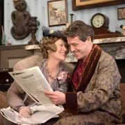 A middle aged woman and man in elegant robe and lounge clothing in a upper class house
