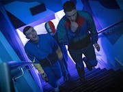 Three young white men walking up purple lit staircase, wearing tracksuits, one wearing an Irish tricolour balaclava