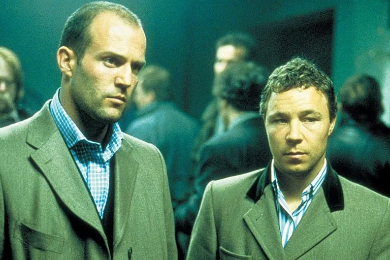 Two white men in smart woollen suits looking serious