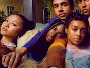 A group of young, cool people lounging against each other