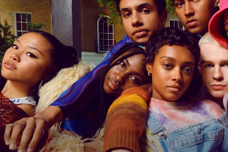 A group of young, cool people lounging against each other