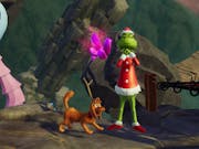 Gameplay of the Grinch, mischievous furry green figure in a red Santa outfit with his brown dog at this feet wearing one antler, standing on a dark stony mountain