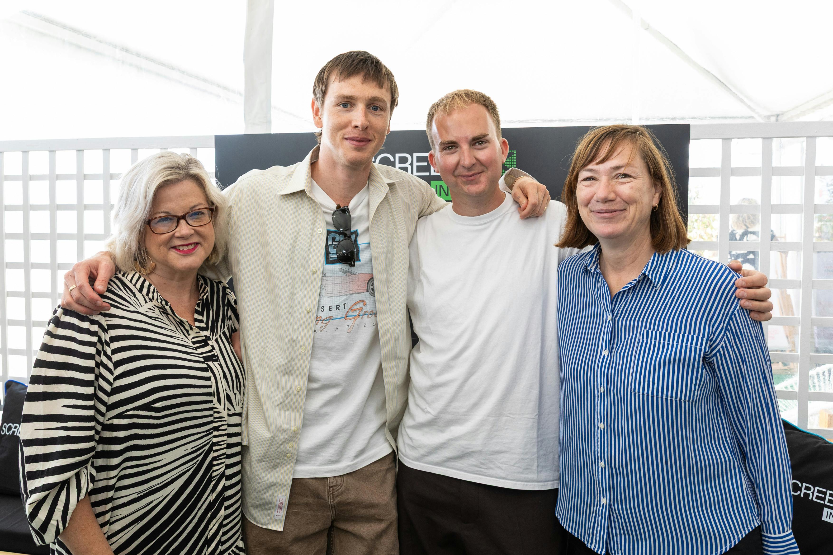 a women, two men, and another women to their right pose for a group photo