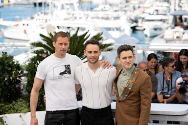 three men pose for a photo