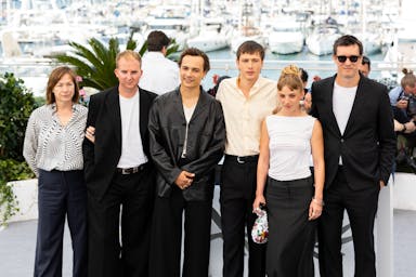 the cast of a film pose for a photo