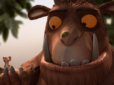 Animation of a large brown furry creature with long teeth, yellow eyes and wart on his nose, gently holding a small mouse
