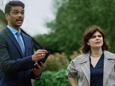 A man and a woman looking to the right of the frame. The man is talking explaining something.