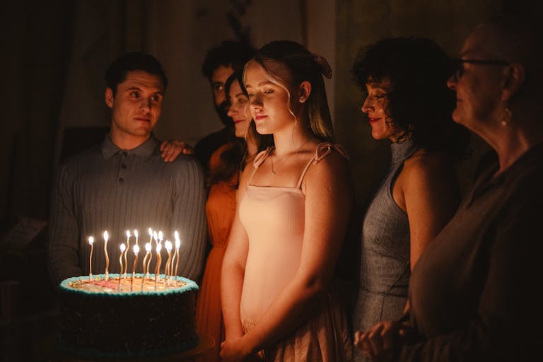 a girl and a cake with lit candles