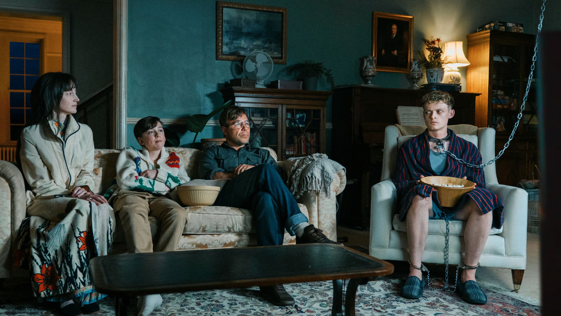 a family sit in a living room