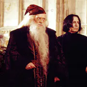 Four wizards with capes and hats looking towards the right of the screen
