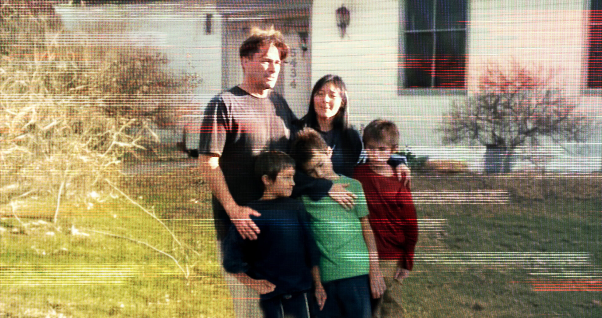 A distorted image of a family with 3 kids posing for a photo
