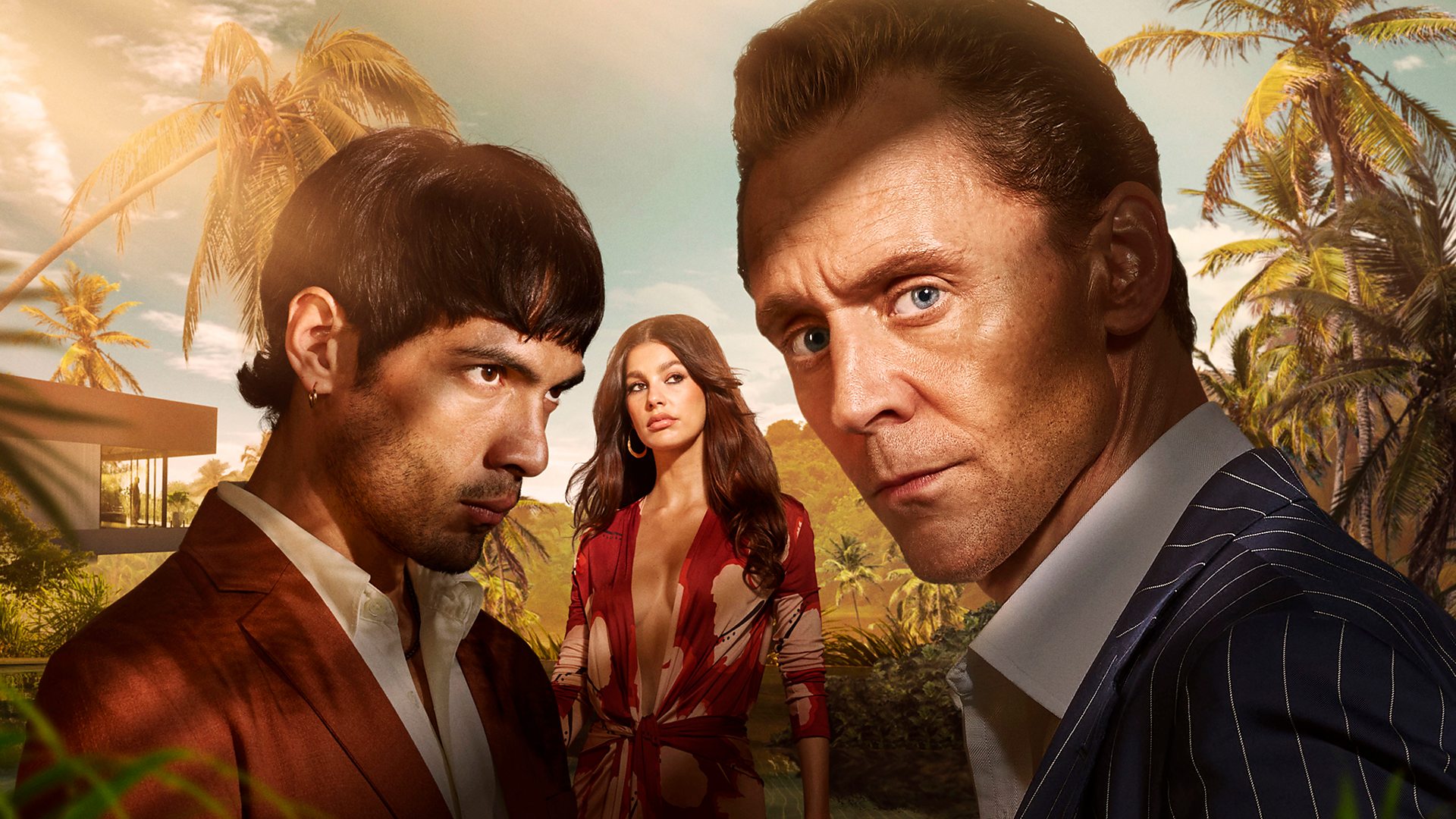 A white man in a pinstripe suit, a young Columbian man in a auburn suit and a Colombian woman in a orange and white floral dress look serious in a tropical location