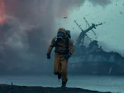 A man in a hazmat suit and mask was away from a ship wreck.