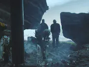 Two men stand over dirt ominously.