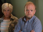 A middle aged white woman and man looking concerned and upset