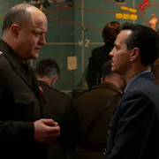 Two white men in Air force uniform facing each other, one visibly more senior