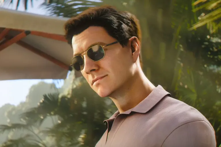 A white man with short, dark hair and sunglasses. Looking mysterious within a jungle