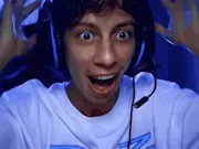 A South Asian young boy wearing a gaming headset, with a shocked look on his face and his hands on his head