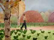 A middle-aged man in farmer-like clothes wandering through a colourful park made of arts and crafts