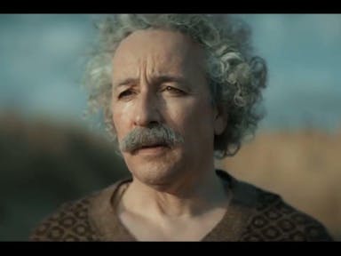 An older white man with big curly white hair and a thick grey moustache looking forlorn  