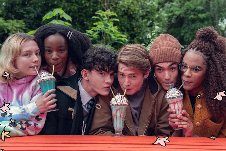 Three pairs of young people each share a milkshake.